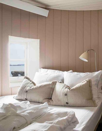 A pale pink clapboard bedrooms